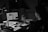 A person using a laptop surrounded by digital devices and notes in a cozy workspace.