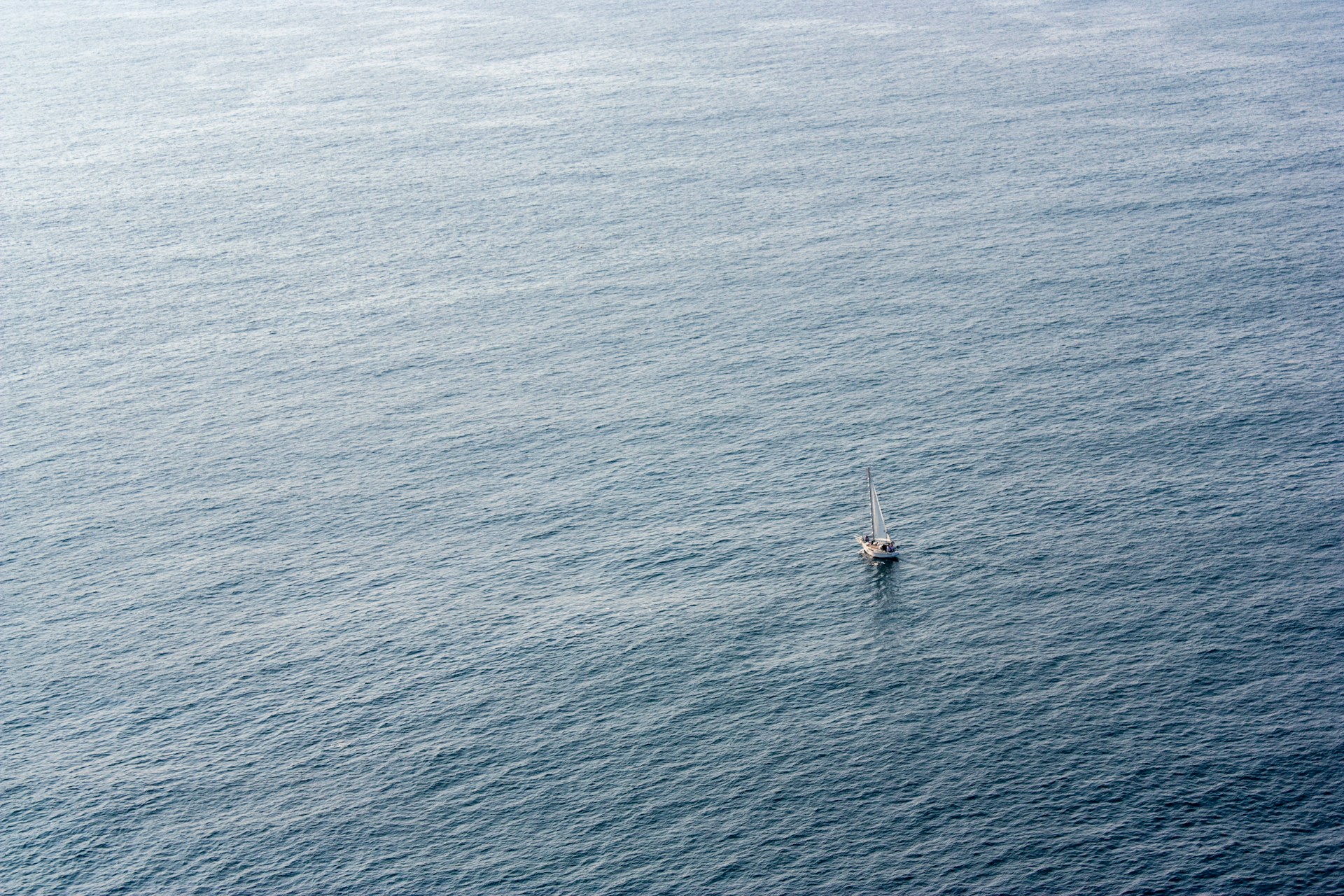 white boat on blue sea during daytime