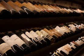 black and white bottles on brown wooden shelf