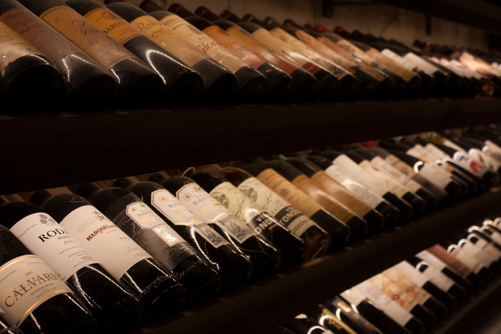 black and white bottles on brown wooden shelf