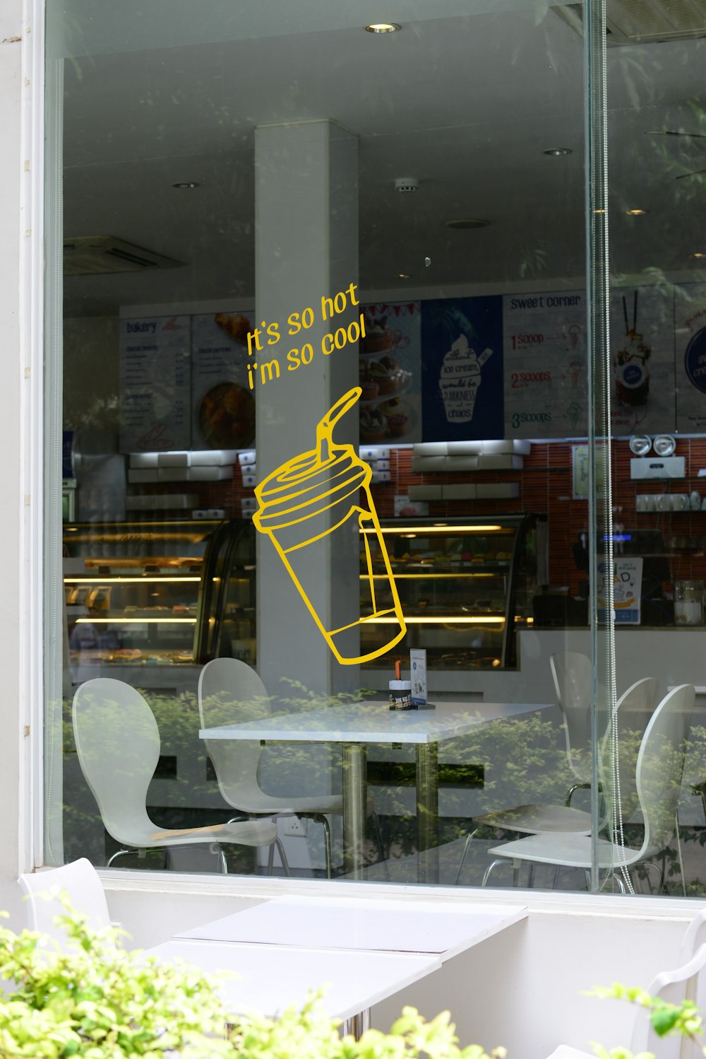 yellow and white metal chair beside glass window