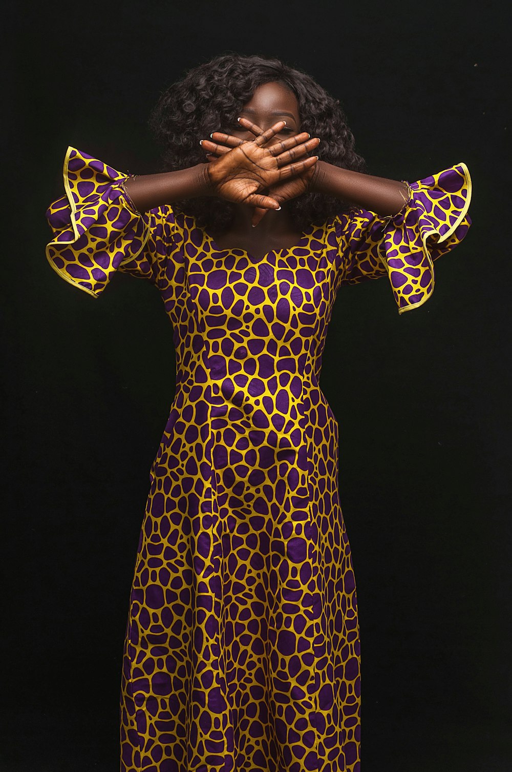 woman in yellow and black polka dot dress