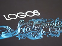 Elegant typography featuring the word 'LOGOS' in white capital letters, paired with an ornate script of 'Steelography' in a flowing, decorative blue font against a dark background.