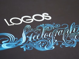 Elegant typography featuring the word 'LOGOS' in white capital letters, paired with an ornate script of 'Steelography' in a flowing, decorative blue font against a dark background.