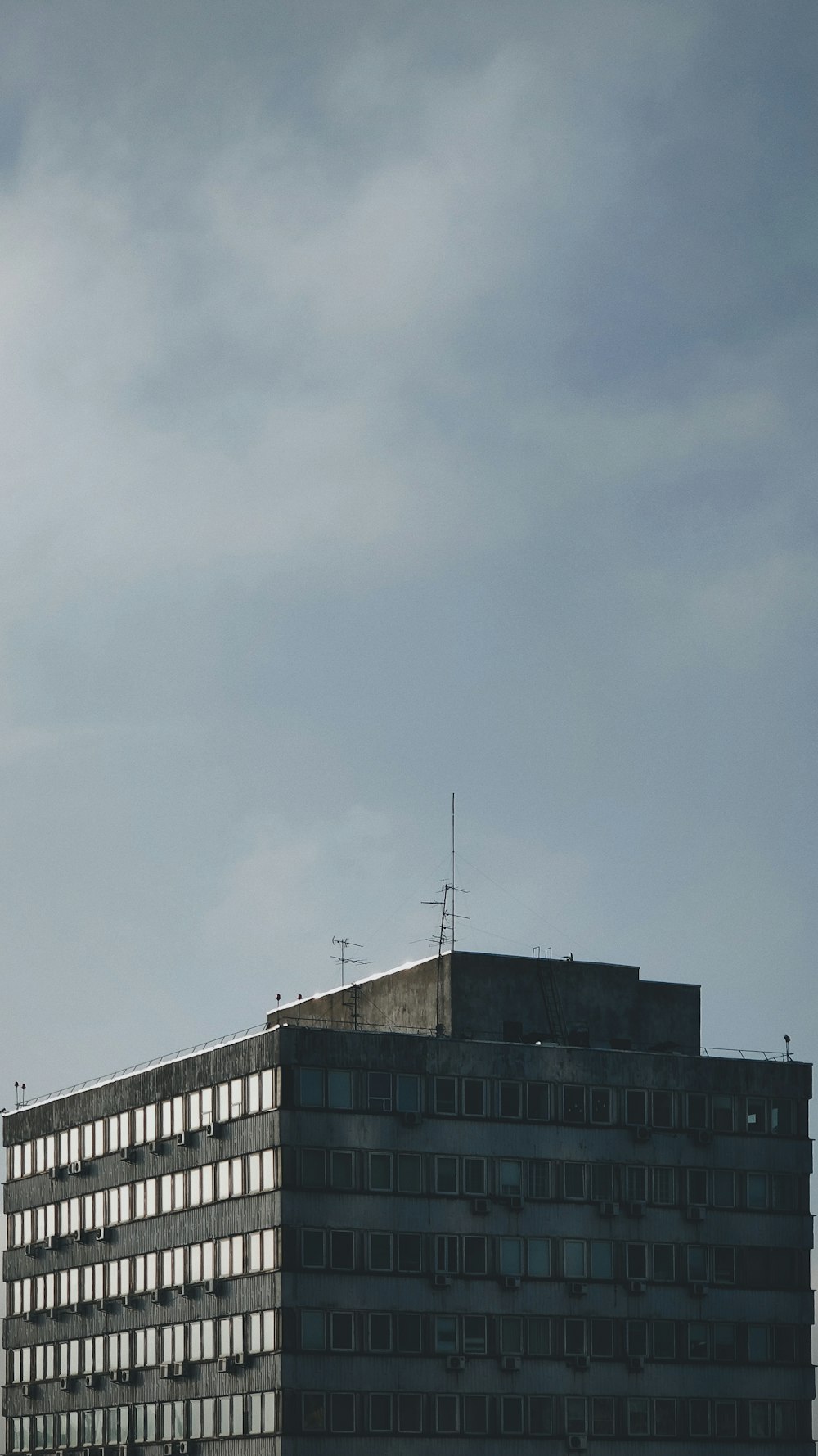 white concrete building under gray sky