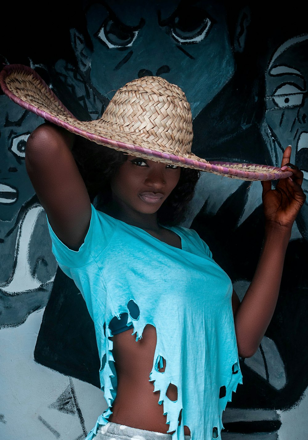 girl in teal shirt and brown straw hat