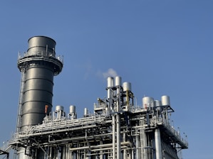 gray and black factory under blue sky during daytime