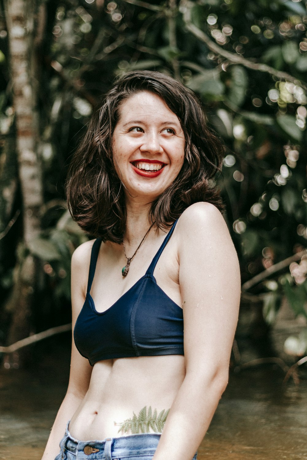 woman in blue bikini top smiling