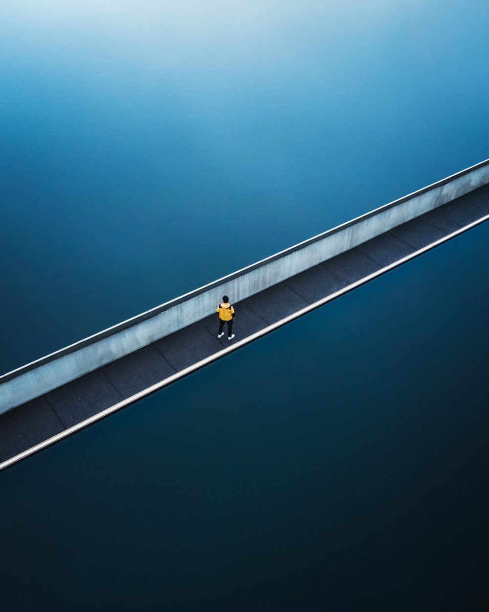 black and yellow traffic light on gray concrete bridge