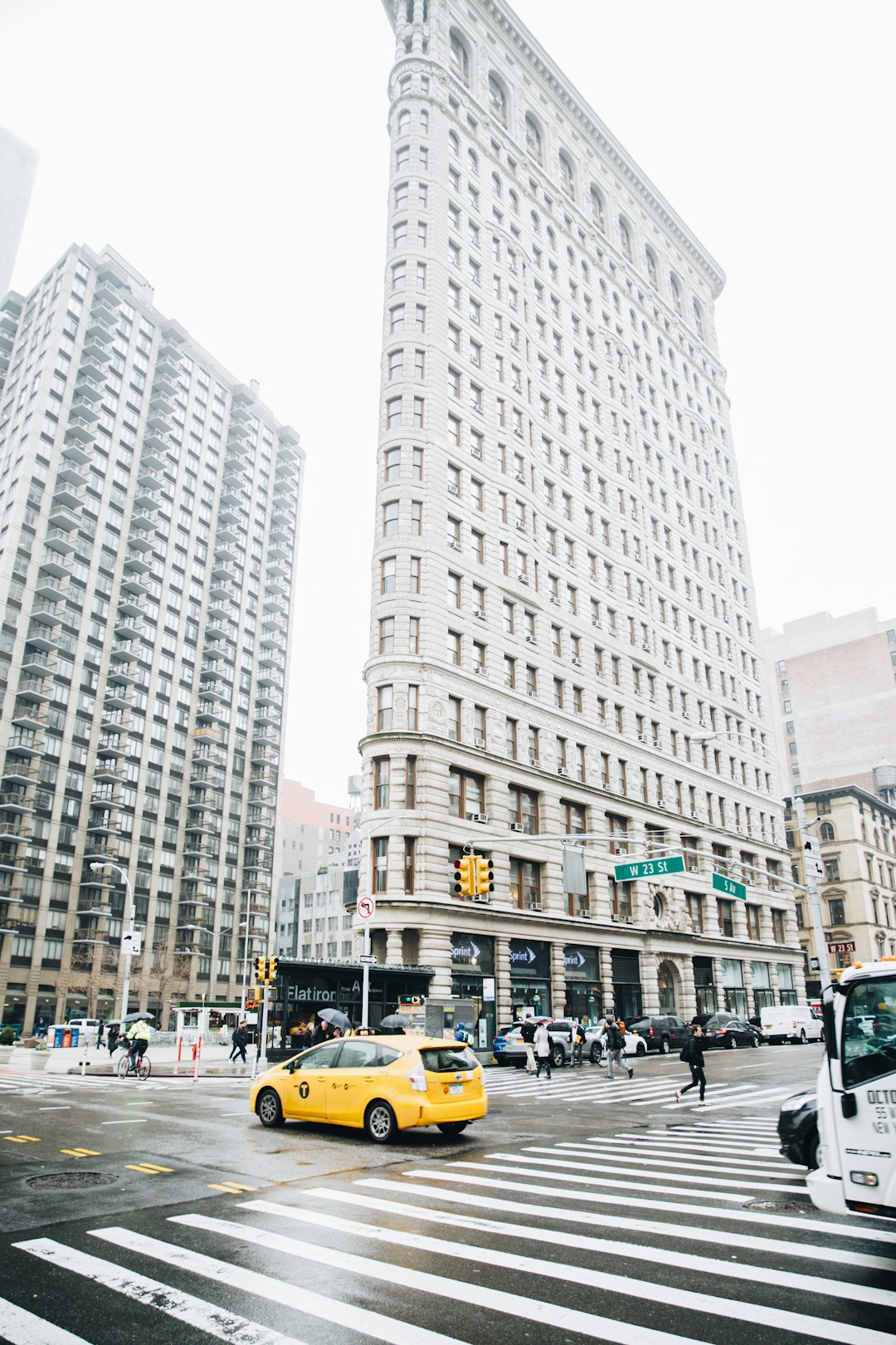 cars on road near high rise buildings during daytime