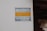 A sign is affixed to a white wall with the text 'MAXISAFE ARMED RESPONSE' in bold letters. The sign also contains a phone number 'Tel: 041 922 0324' at the bottom. The colors used in the sign are blue for 'MAXISAFE' and the phone number, and yellow for 'ARMED RESPONSE'. The right side of the image shows part of a brick structure, likely part of a building.