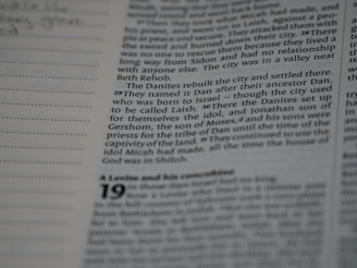 A close-up view of a printed page with text, featuring a column of writing on the right and a section with dotted lines on the left. The text appears to be from a book or document, with numbers indicating verses or sections.