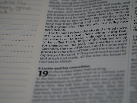 A close-up view of a printed page with text, featuring a column of writing on the right and a section with dotted lines on the left. The text appears to be from a book or document, with numbers indicating verses or sections.