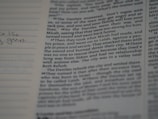 A close-up of an open book with handwritten notes.