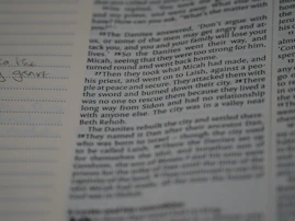 Close-up of an open guidebook showing various university majors and specializations.