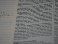 Close-up of an open guidebook showing various university majors and specializations.