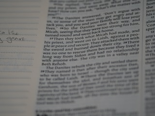 A close-up of a textbook and notes on a table.