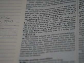 A close-up of an open workbook filled with handwritten notes and screenplay formatting tips.