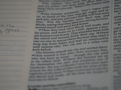 A close-up of an open book with handwritten notes and sketches about angel investors.