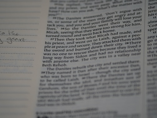 A close-up of an open book with notes and a pen.