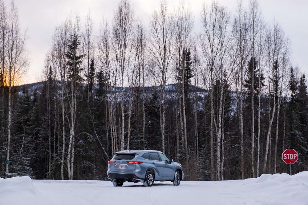 black suv on snow covered road during daytime