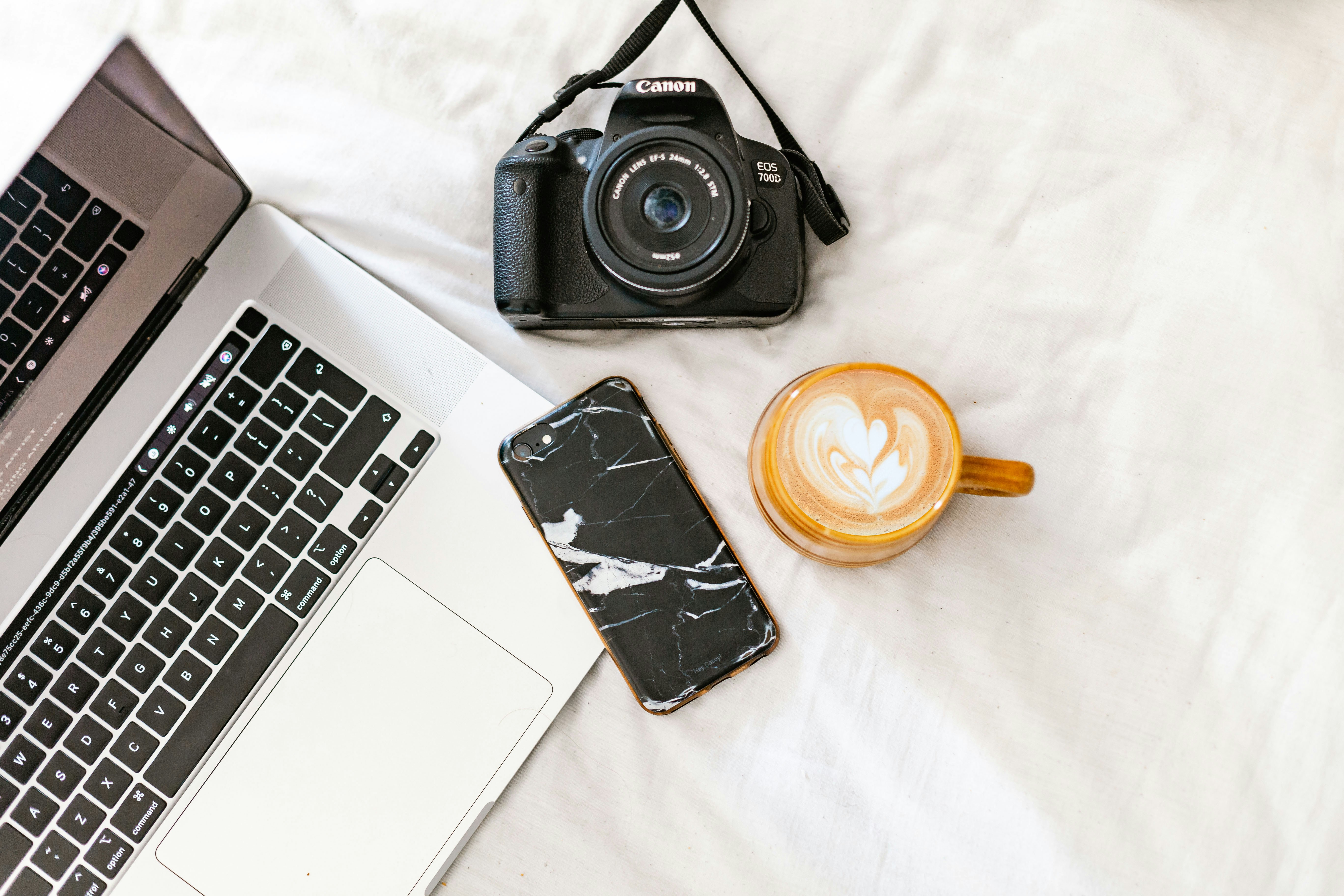 black nikon dslr camera beside macbook pro