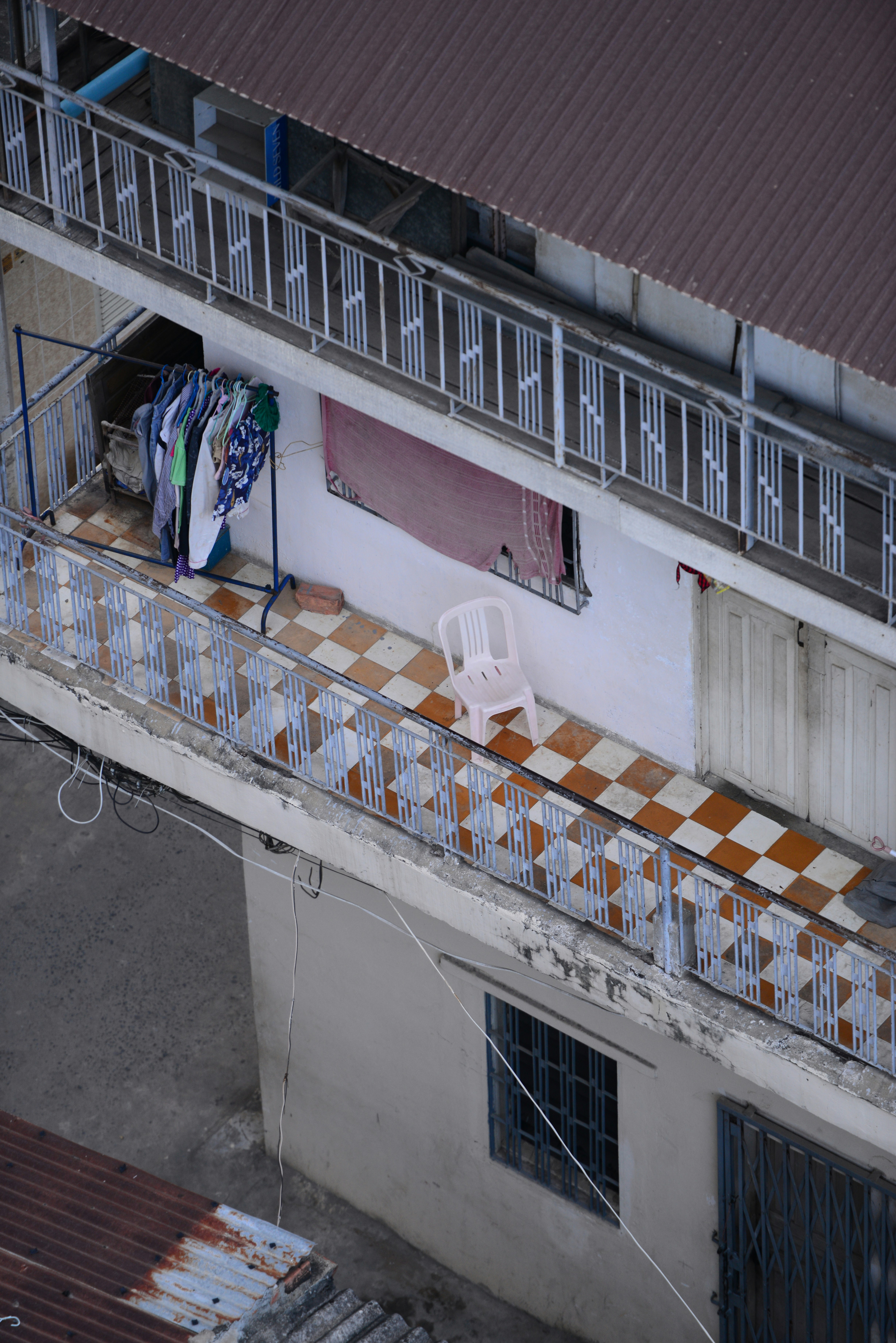 white plastic chairs on white metal rack