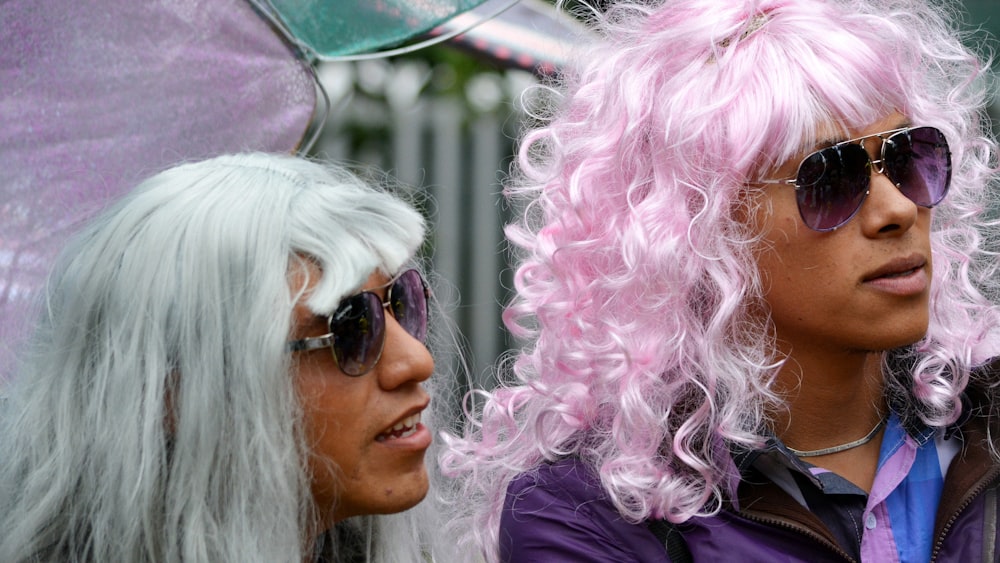 woman in black sunglasses with pink hair