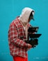 man in red white and black plaid dress shirt holding black dslr camera
