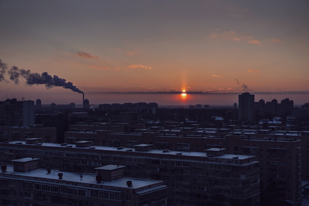 city skyline during sunset with orange sky