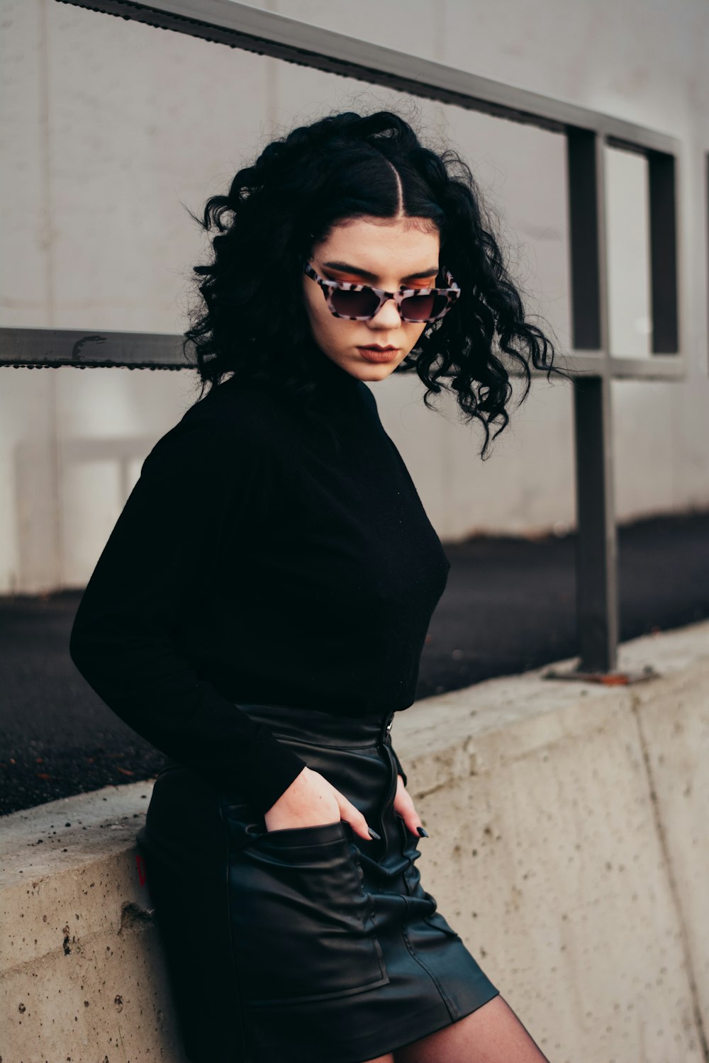 woman in black long sleeve shirt and black pants wearing black sunglasses