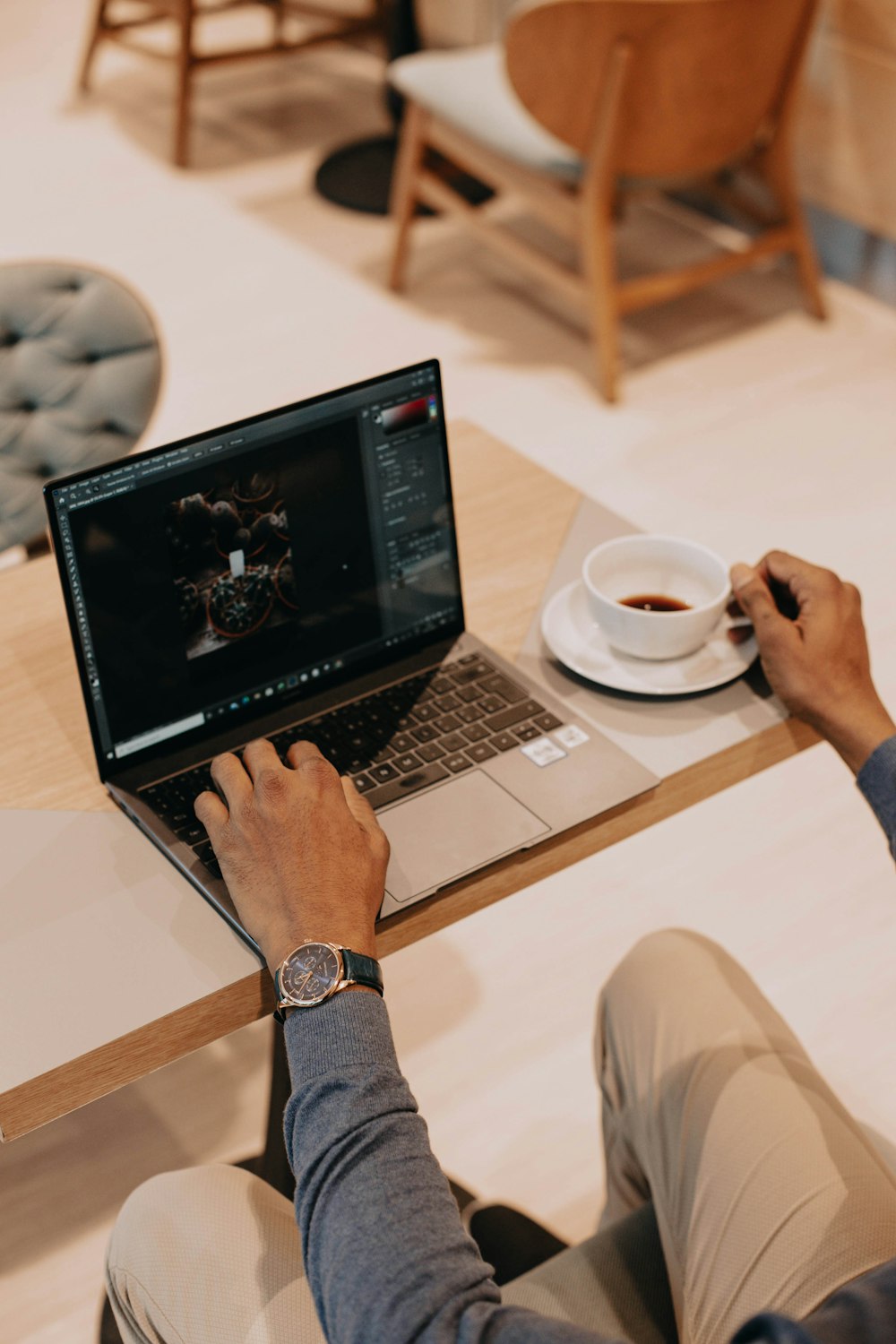 person using macbook pro on white table