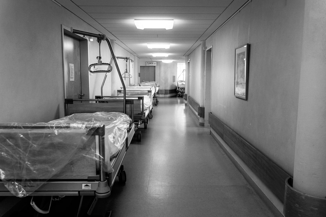 grayscale photo of hospital bed
