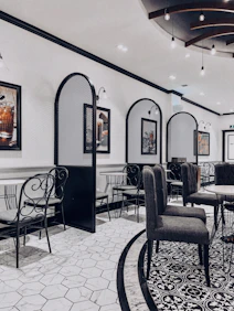 Interior dining area with modern lighting, muted gold accents, and a harmonious blend of comfort and style.