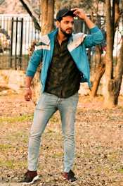 Man wearing a casual jacket standing outdoors in natural light.