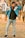 A happy man wearing stylish casual clothing outdoors.
