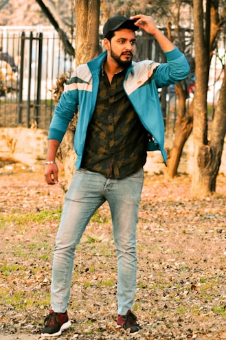 A well-dressed man in casual attire outdoors.