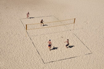 Outdoor sand courts with players enjoying beach tennis under the sun