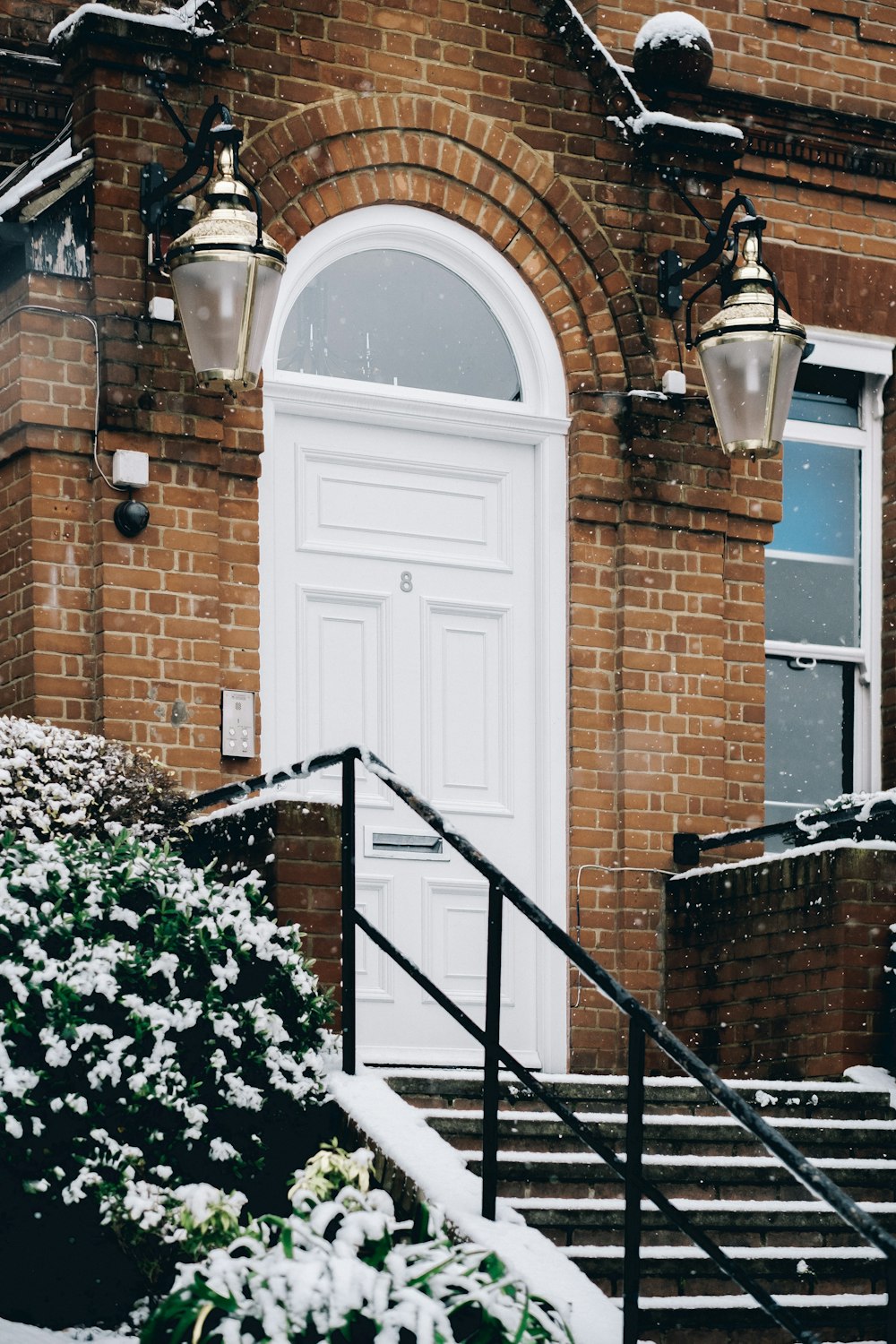 black metal railings near brown brick wall