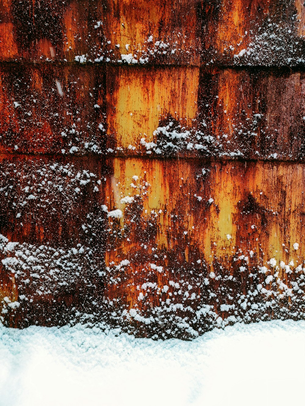 brown wooden wall with snow