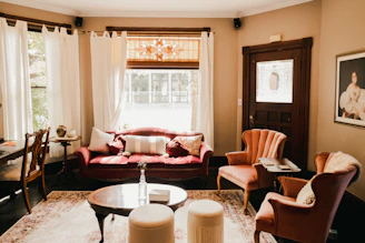 A stylish living room featuring plush seating, warm lighting, and tasteful decor.