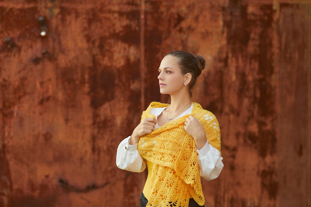 woman in yellow and white dress holding yellow scarf
