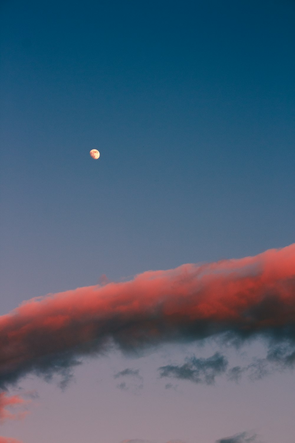 full moon over orange clouds