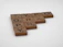 Wooden Scrabble tiles arranged to spell the word 'TYPOGRAPHY'. Each tile has a letter and a number indicating its point value. The tiles are placed against a plain white background.