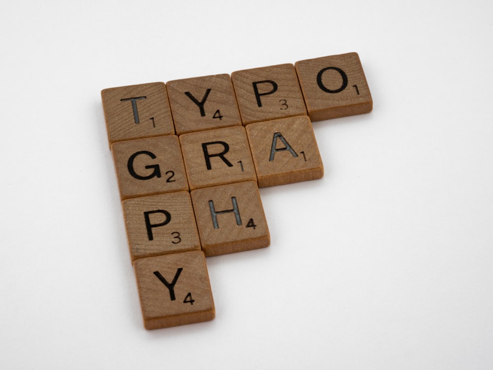 a scrabble of letters that spell out the word typograph