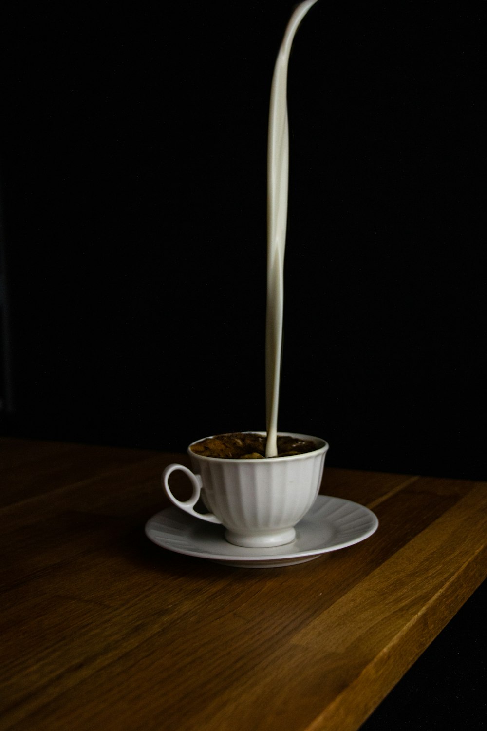 white ceramic teacup on saucer