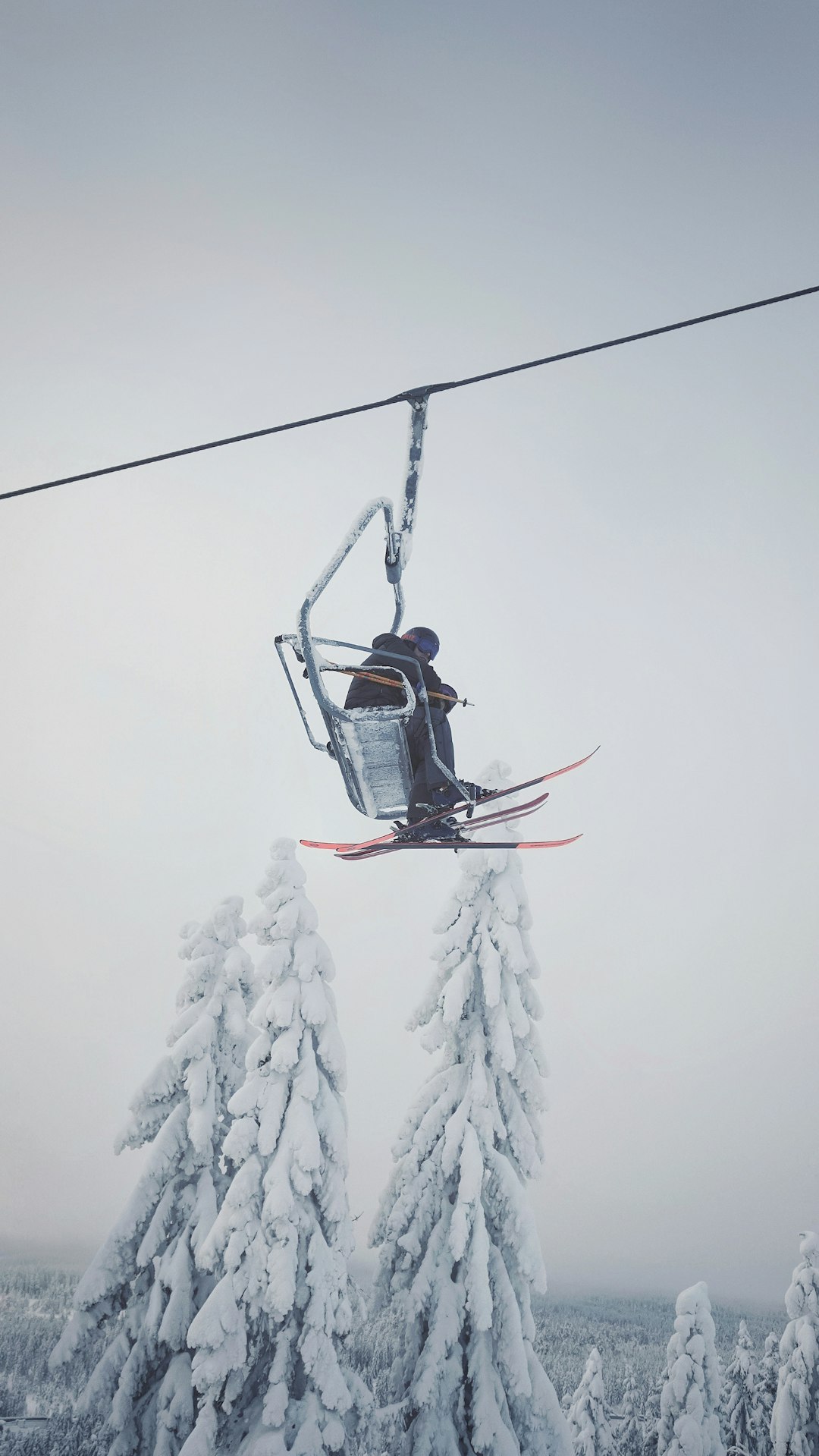 person in black jacket riding on cable car during daytime