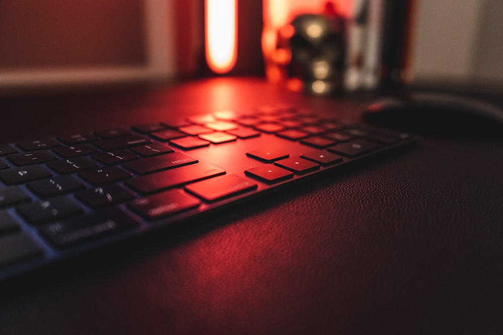 black computer keyboard on red surface