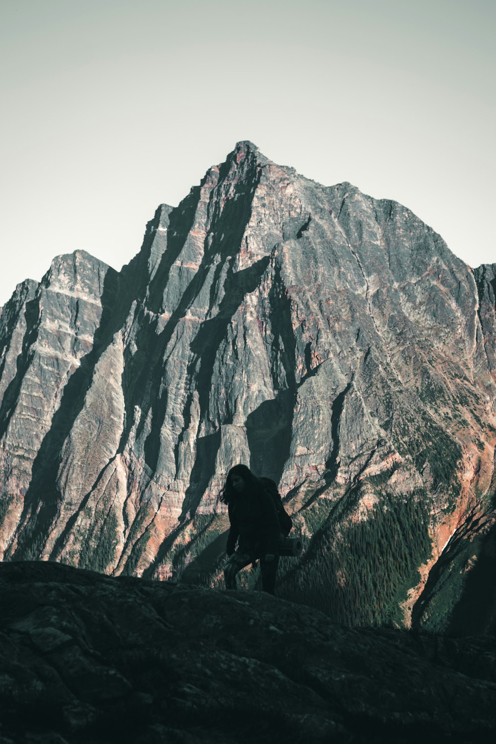 person standing on rock formation during daytime