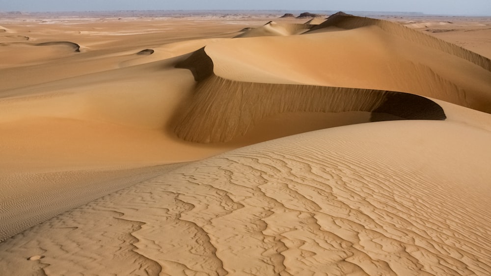 brown sand dunes during daytime